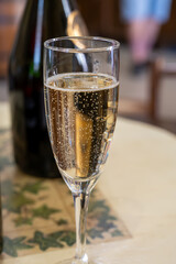 Pouring and tasting of dry sparkling wine brut, grand reserve, champagne in Ay-Champagne wine making village in Vallee de la Marne, , Champagne region, France