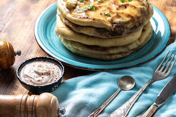 Traditional spanish breakfast potato tortilla. Potatoes in a cast iron frying pan on a rustic...