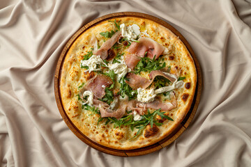 Savor the exquisite flavors of gourmet Italian pizza topped with rich cream, fresh arugula, and delicate prosciutto, beautifully presented in an elegant restaurant setting