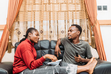 Casual Conversation Between Friends Sitting Comfortably on a Couch at Home