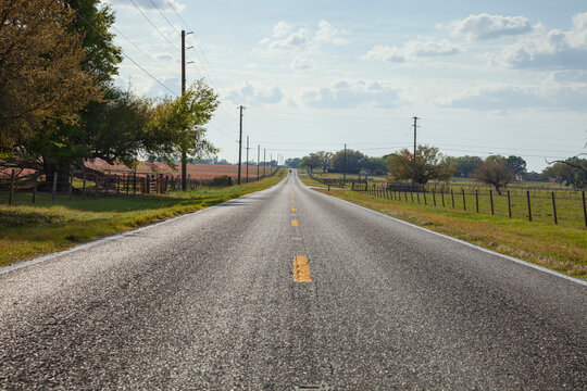 Low angle view of two lane asphalt highway in rural central Florida on a sunny afternoon