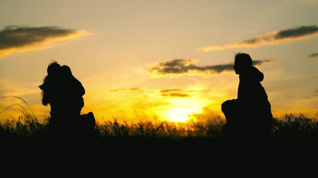 Parenting moments in golden light, running and laughing in nature, dusk setting and happy smiles, unconditional love in a scenic landscape, memorable childhood adventure, peaceful outdoor joy