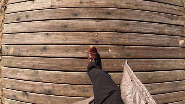 POV Walk: Person Stepping on Wooden Boardwalk in Kipsala Riga Area