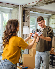 A woman is film a man hold cctv security camera and give instructions