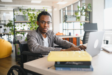 African american student using laptop in modern office