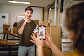 A woman is film a man hold cctv security camera and give instructions