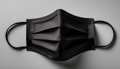 black disposable face mask on a plain background