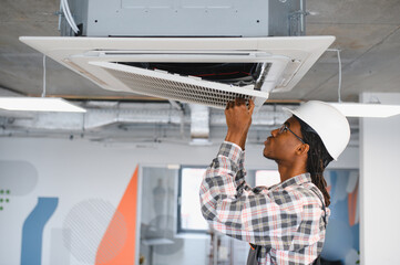 Plakat Technician repairing air conditioning ventilation system in office building