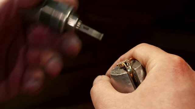 Skilled jeweler delicately setting a gemstone into a jewelry piece
