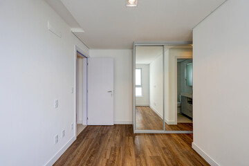 Modern unfurnished apartment interiors with natural light, white walls, hardwood or light flooring, built-in kitchen, and clean architectural design, ideal for real estate or interior design concepts