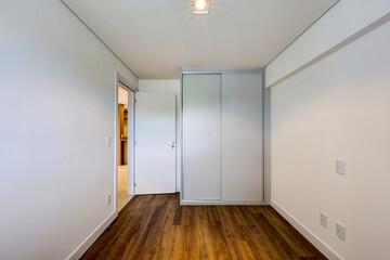 Modern unfurnished apartment interiors with natural light, white walls, hardwood or light flooring, built-in kitchen, and clean architectural design, ideal for real estate or interior design concepts