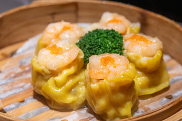 Chinese steamed pork dumplings, Siu Mai, in bamboo steamers
