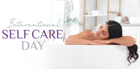 Beautiful young happy woman relaxing in bathtub at home