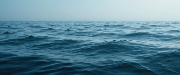 Fototapeta premium Serene Ocean Waves Under Clear Sky Captured at Early Morning Light with Subtle Textures and Calm Atmosphere