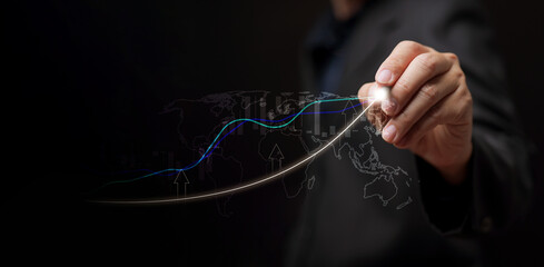 Business growth, economic development, or investment concept: A man draws an upward trending line alongside a graph, symbolizing success, progress, and rising market performance