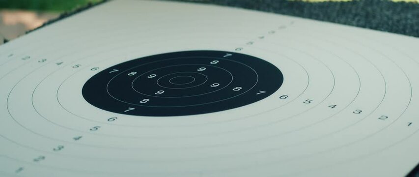 Paper target with concentric rings placed on table during shooting practice