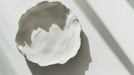 Handcrafted white bowl in sunlight