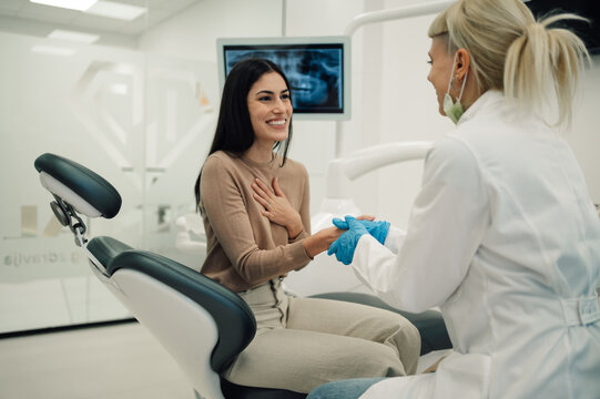 Female dentist reassuring patient before dental procedure