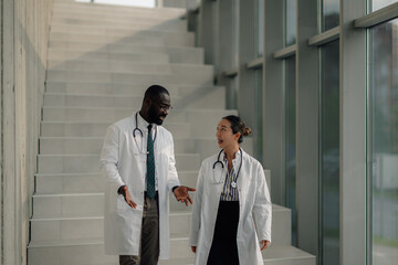 Doctors discussing patient status while walking down hospital stairs © Zamrznuti tonovi