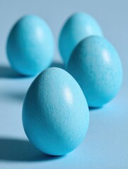Four blue easter eggs on light blue background studio shot close up easter holiday decoration pastel color