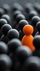 Orange Figure Standing Out in Crowd of Black Figures Close Up Abstract Concept of Individuality Leadership Uniqueness