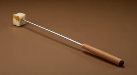 Fondue time: a studio shot showcasing a piece of bread skewered on a fondue fork