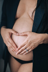pregnant woman holding hands on her belly