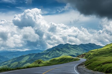 Naklejka premium Scenic winding road through lush green mountains under dramatic cloudy sky aerial view landscape travel destination nature photography