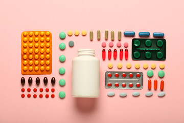 Different pills on pink background