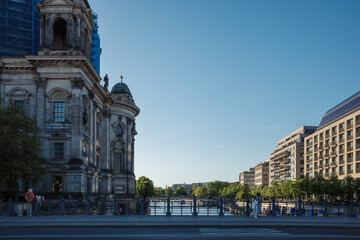 A riverside view in Berlin, Germany, capturing a partial facade of the historic Berlin Cathedral (Berliner Dom), with visible scaffolding, alongside the Spree River in Berlin, Germany.  © Peeradontax