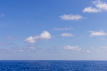 Fototapeta premium Scenic Cloudscape Over Calm Pacific Ocean on a Clear Sunny Day