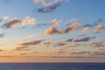 Colorful Cloudscape at Sunset Above Calm Pacific Ocean Waters