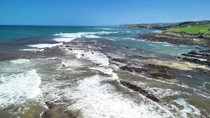 A Beautiful Aerial View of Serene Coastal Ocean Waves Flowing Against a Rocky Shoreline