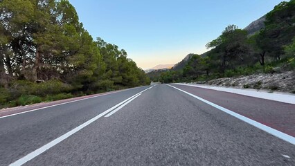 A Beautiful Scenic Mountain Road at Sunset, Perfect for a Relaxing Outdoor Drive, Inviting Adventure