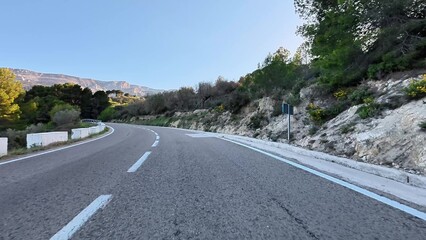 A Scenic Winding Road That Curves Through Lush Greenery and Beautiful Rolling Hills