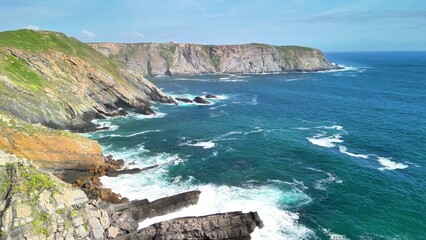 The breathtaking coastal landscape featuring crashing waves and majestic cliffs is truly stunning