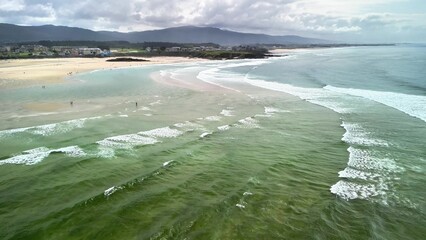 Breathtaking Scenic Aerial View of a Serene Beach with Gentle Waves Lapping the Shore