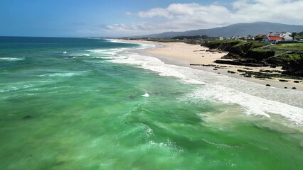 Experience the Stunning Aerial View of a Beautiful and Serene Beach with Turquoise Waters