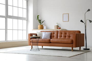 Brown leather sofa and coffee table in interior of living room