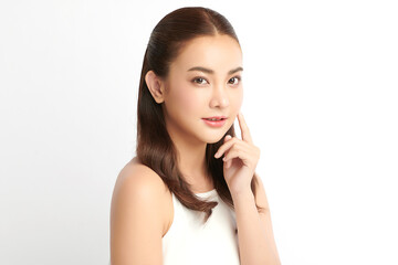 Fototapeta premium A beautiful young Asian woman with clean, fresh skin against a white background. Skincare, facial treatment, cosmetology, beauty, and spa. An elegant portrait of an Asian woman.