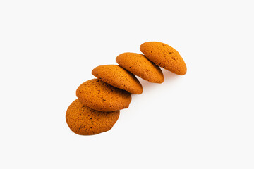 Freshly baked cookies arranged in a neat line on white surface