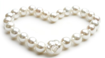 Obraz premium Heart-shaped pearl necklace on white background, romantic jewelry, Valentine's Day gift