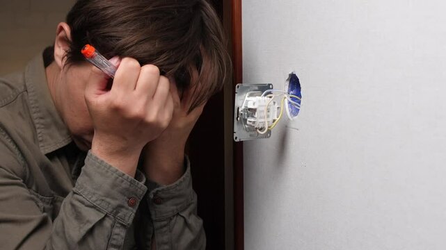 Stressed electrician making mistakes while installing light switch