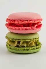 Colorful macaron desserts stacked on a white surface