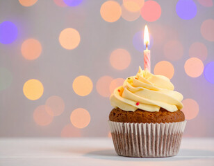 Delicious birthday cupcake with burning candle, surrounded by colorful blurred lights, creating festive atmosphere