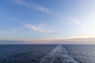 Fototapeta premium Open Ocean Scene During Sunset with Distant Ship on Horizon