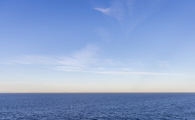 Tranquil Sky Above a Vast Blue Ocean Horizon at Sunset