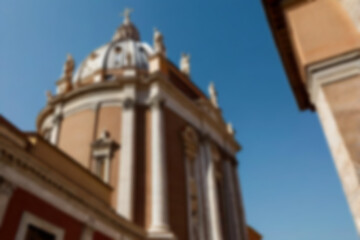 Obraz premium blurry church, a church building in the vatican with a clear sky during the day, seen in the photo from the front, with the blurry vatican church in the background