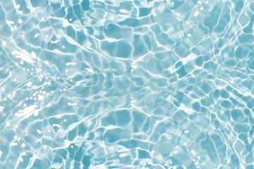 Blue water with ripples on the surface. Defocus blurred transparent blue colored clear calm water surface texture with splashes and bubbles. Water waves with shining pattern texture background.