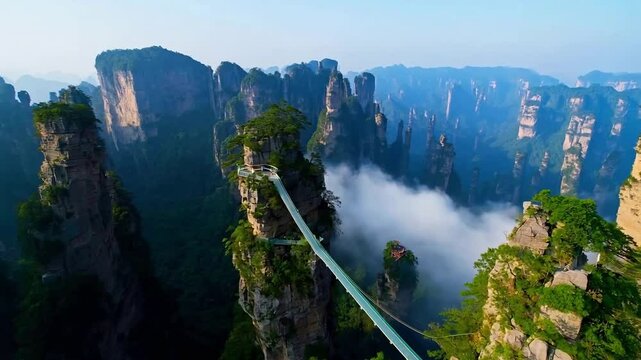 The clouds are swirling around the mountains in Zhangjiajie, China, presenting a breathtaking sight of unique peaks.